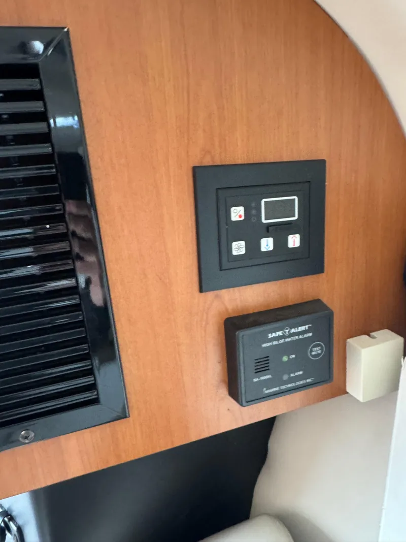 Slide: The Image of Control panel and alarm system inside a 2008 Crownline 315 SCR boat cabin. - 23