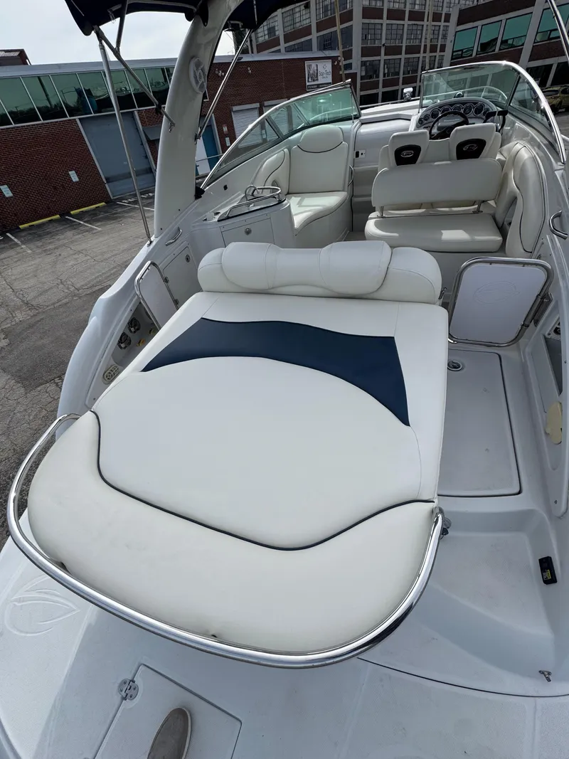 Slide: The Image of 2008 Crownline 315 SCR boat interior with white seating and steering area. - 5