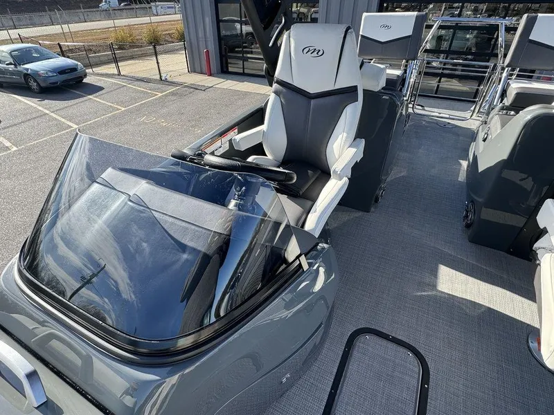 Slide: The Image of 2024 Manitou XT 23 Split Rear Sport (SRS) Single Engine V-Toon boat interior with captain's chair. - 14
