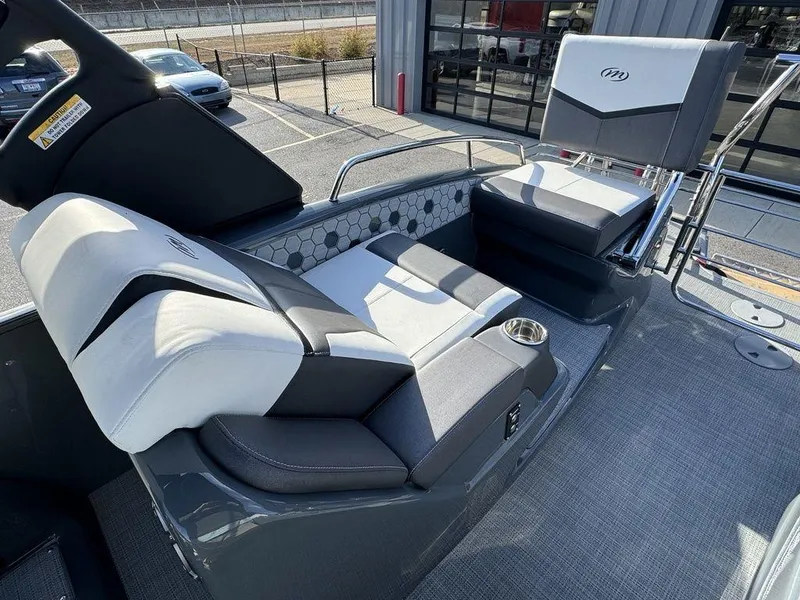 Slide: The Image of 2024 Manitou XT 23 Split Rear Sport (SRS) Single Engine V-Toon boat interior with luxurious seating. - 19