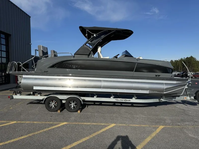 Slide: The Image of 2024 Manitou XT 23 Split Rear Sport (SRS) Single Engine V-Toon pontoon boat on trailer. - 3