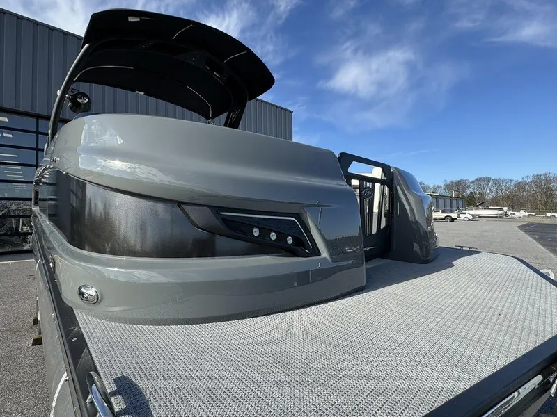 Slide: The Image of 2024 Manitou XT 23 Split Rear Sport (SRS) Single Engine V-Toon pontoon boat, docked. - 8