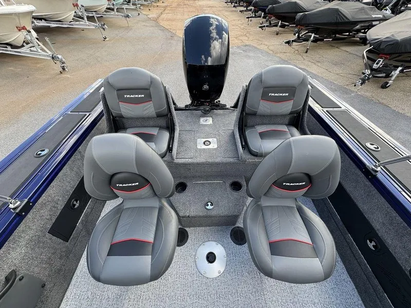 Slide: The Image of 2024 Tracker Targa™ V-18 Combo boat interior with four grey seats and motor. - 24