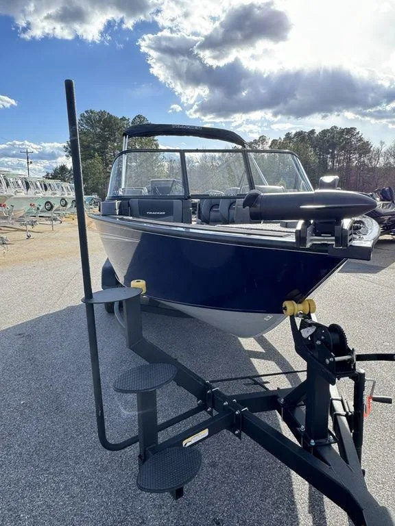 Slide: The Image of 2024 Tracker Targa™ V-18 Combo boat on a trailer under a partly cloudy sky. - 9