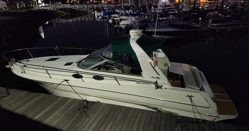 Slide: The Image of 1999 Sea Ray 290 Sundancer docked at night in a marina. - 4