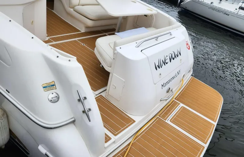 Slide: The Image of 1999 Sea Ray 290 Sundancer boat with teak deck, docked at marina. - 5