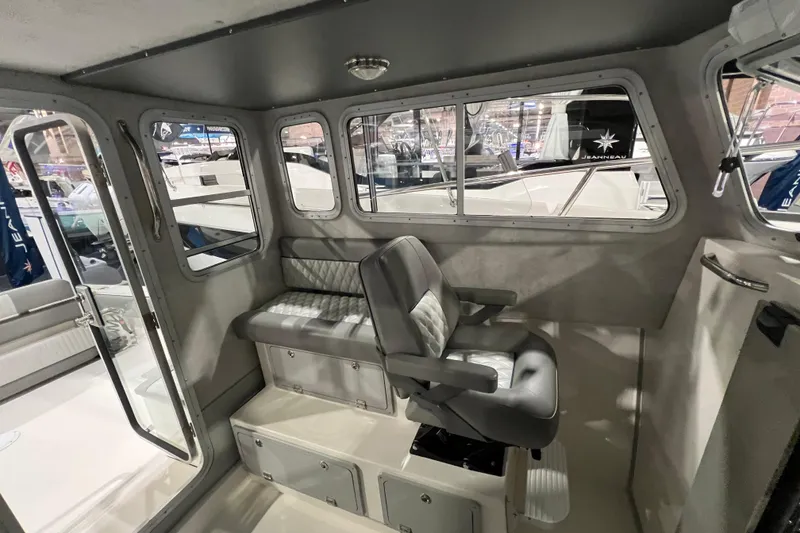 Slide: The Image of Interior of 2025 Defiance 260 Admiral boat with seating and windows. - 12