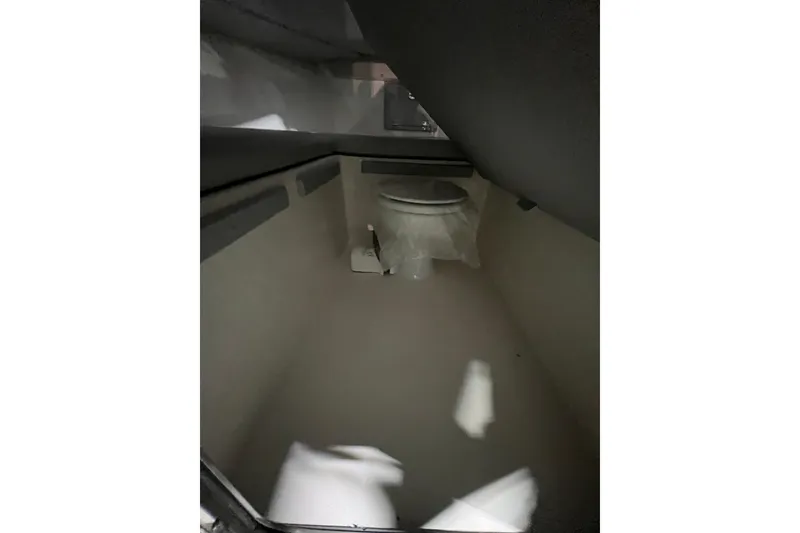 Slide: The Image of Interior of 2025 Defiance 260 Admiral boat featuring a compact bathroom space. - 14