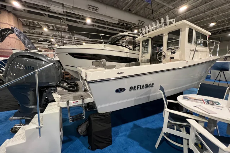 Slide: The Image of 2025 Defiance 260 Admiral boat displayed indoors with Yamaha engine. - 3