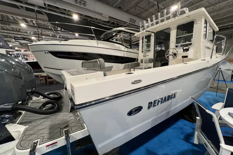 Slide: The Image of 2025 Defiance 260 Admiral boat displayed at an indoor exhibition, showcasing sleek design and features. - 4