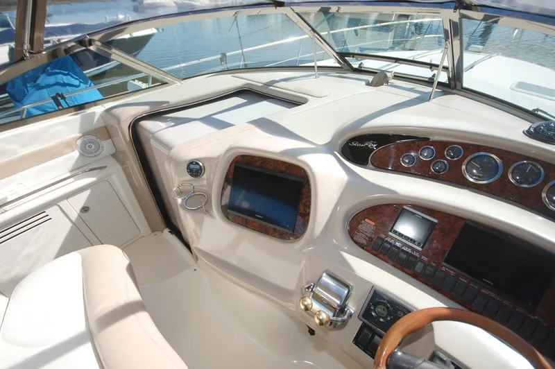 Slide: The Image of Helm of 2000 Sea Ray 380 Sundancer with navigation instruments and steering wheel. - 10