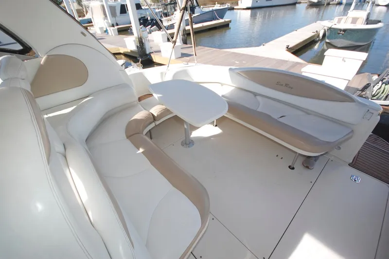 Slide: The Image of Sea Ray 380 Sundancer 2000 boat interior with seating and table at marina. - 13