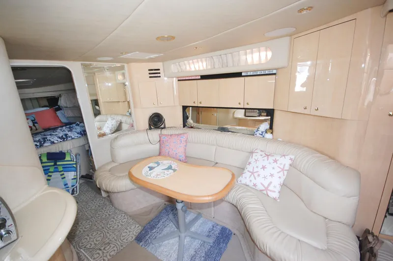 Slide: The Image of Interior of 2000 Sea Ray 380 Sundancer with beige leather seating and wooden cabinetry. - 17