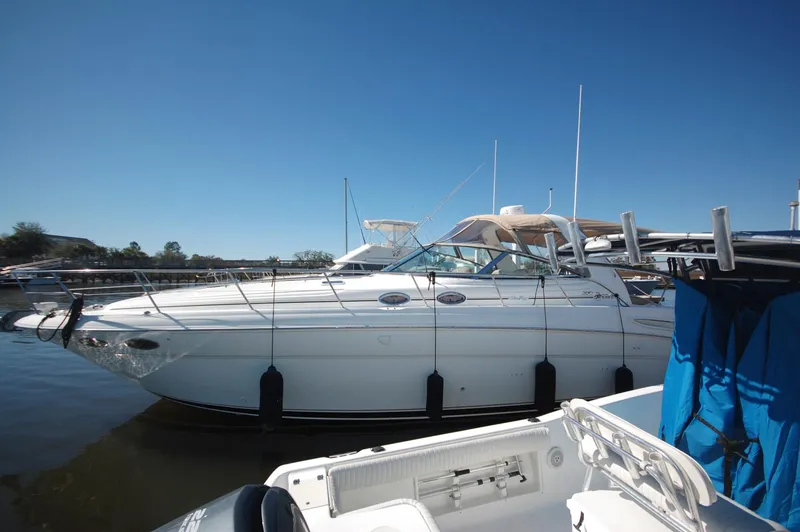 Slide: The Image of 2000 Sea Ray 380 Sundancer docked at a marina on a sunny day. - 2