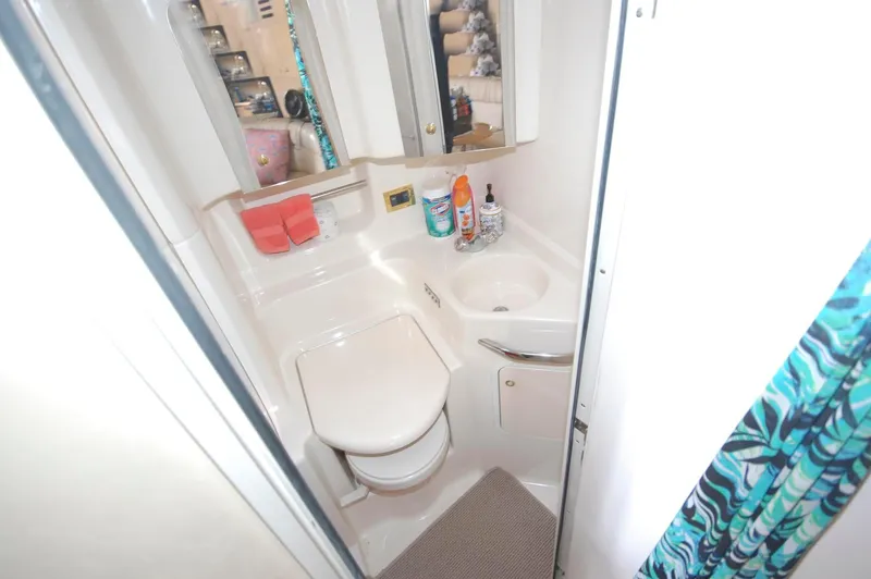 Slide: The Image of Compact bathroom in 2000 Sea Ray 380 Sundancer yacht with sink, toilet, and mirror. - 20