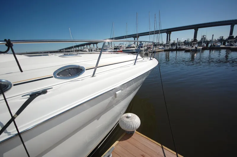 Slide: The Image of Sea Ray 380 Sundancer 2000 docked at marina with bridge in background. - 3