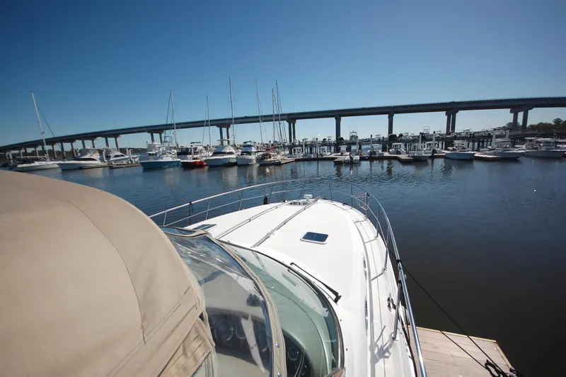 Slide: The Image of Sea Ray 380 Sundancer 2000 docked at marina with bridge in background. - 5