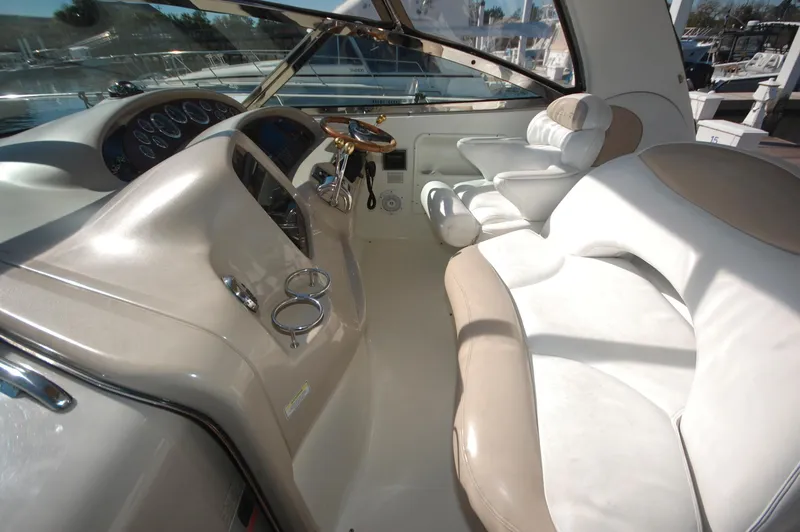 Slide: The Image of Interior cockpit of a 2000 Sea Ray 380 Sundancer yacht with beige seating and control panel. - 8