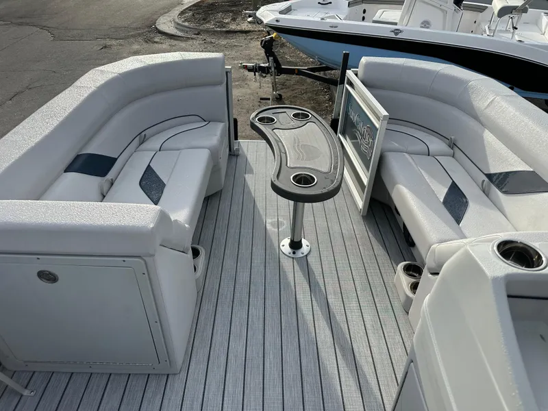 Slide: The Image of 2024 SunCatcher Select 20RC pontoon boat interior with seating and table. - 14