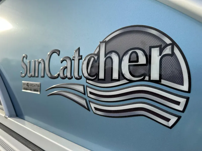 Slide: The Image of 2024 SunCatcher Select 20RC logo on blue boat exterior. - 18