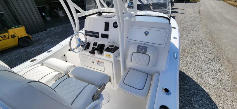 Slide: The Image of 2024 Sea Fox 248 Side Console boat interior with white seating and control panel. - 5