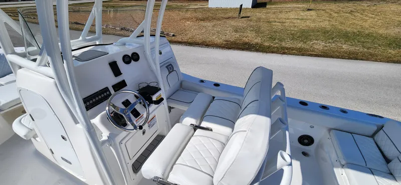 Slide: The Image of 2024 Sea Fox 248 Side Console boat interior with white seating and steering console. - 6
