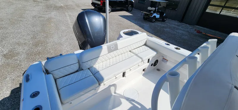 Slide: The Image of 2024 Sea Fox 248 Side Console boat interior with cushioned seating and outboard motor. - 8