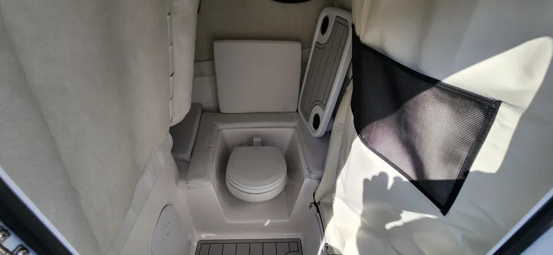 Slide: The Image of 2024 Sea Fox 248 Side Console boat interior with a compact marine toilet. - 9