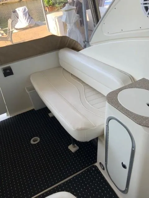Slide: The Image of Interior seating area of a 2000 Maxum 3300 SCR boat with white upholstery. - 11