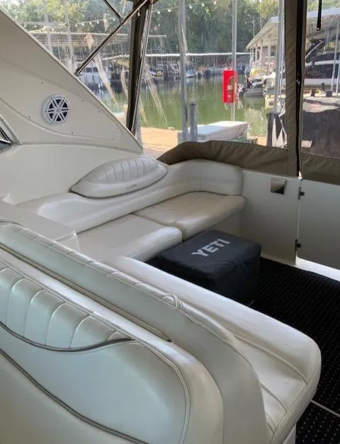 Slide: The Image of 2000 Maxum 3300 SCR boat interior with white leather seating and Yeti cooler. - 12
