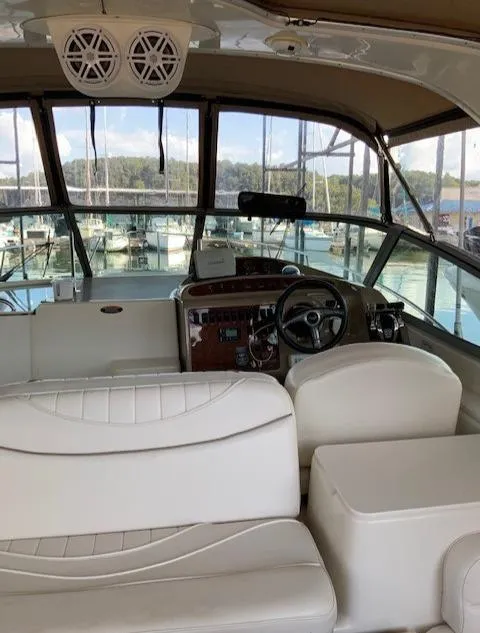Slide: The Image of Interior of 2000 Maxum 3300 SCR yacht with white seating and helm station. - 13