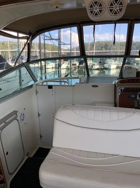 Slide: The Image of Interior of a 2000 Maxum 3300 SCR boat with white seating and control panel. - 14