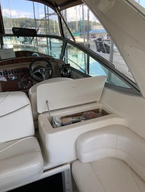 Slide: The Image of Interior of a 2000 Maxum 3300 SCR boat with white seating and storage compartment. - 15
