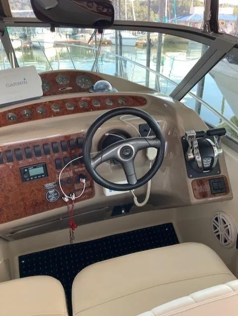 Slide: The Image of Helm of a 2000 Maxum 3300 SCR boat with steering wheel and control panel. - 16