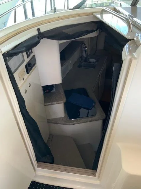 Slide: The Image of Interior cabin of 2000 Maxum 3300 SCR boat with kitchenette and seating area. - 17