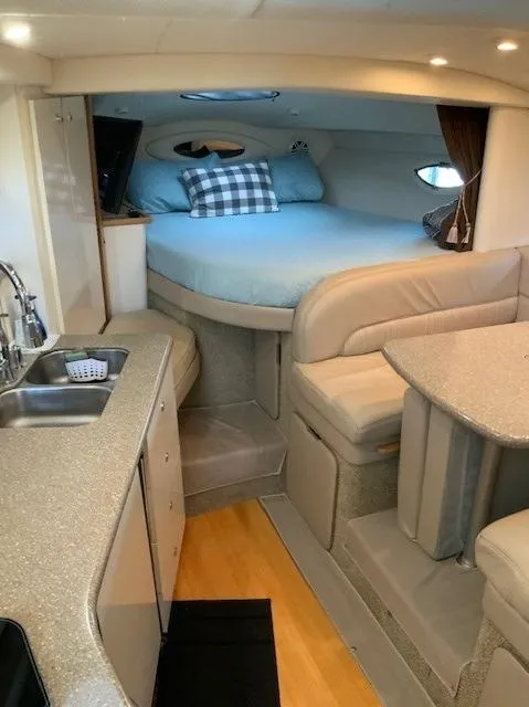 Slide: The Image of Interior of 2000 Maxum 3300 SCR yacht with bed, kitchenette, and seating area. - 18