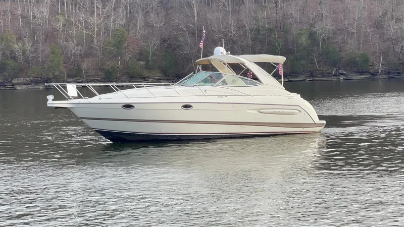 Slide: The Image of 2000 Maxum 3300 SCR boat cruising on a calm lake. - 2