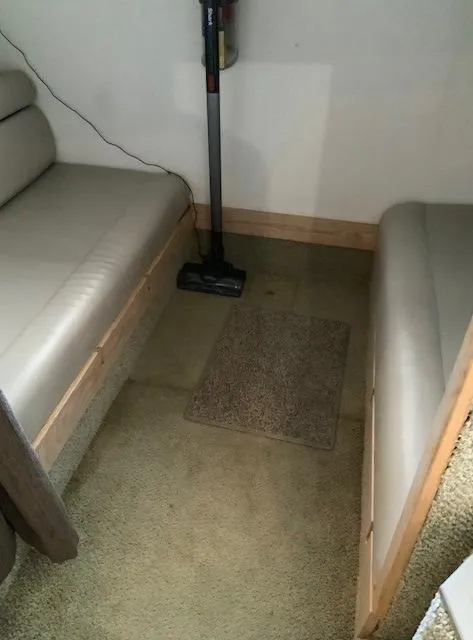 Slide: The Image of Interior of a 2000 Maxum 3300 SCR boat with seating and vacuum cleaner. - 24