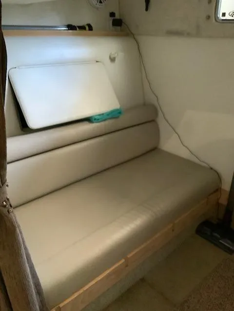 Slide: The Image of Interior seating area of 2000 Maxum 3300 SCR boat with beige cushions. - 25