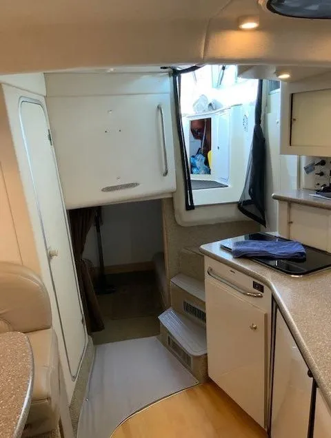 Slide: The Image of Interior of a 2000 Maxum 3300 SCR boat with kitchen and seating area. - 27