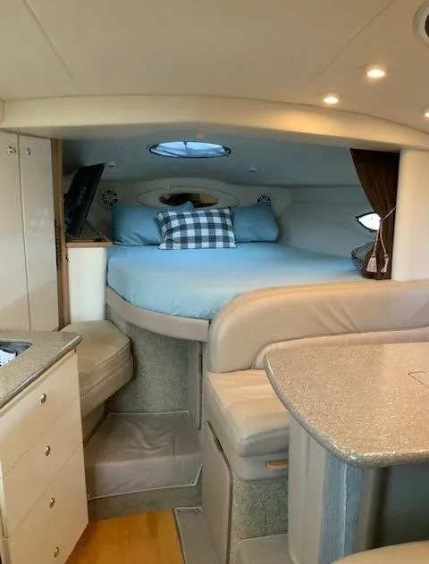 Slide: The Image of Interior cabin of a 2000 Maxum 3300 SCR yacht with bed and seating area. - 28