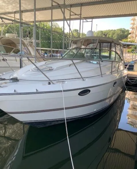 Slide: The Image of 2000 Maxum 3300 SCR boat docked in a marina. - 3