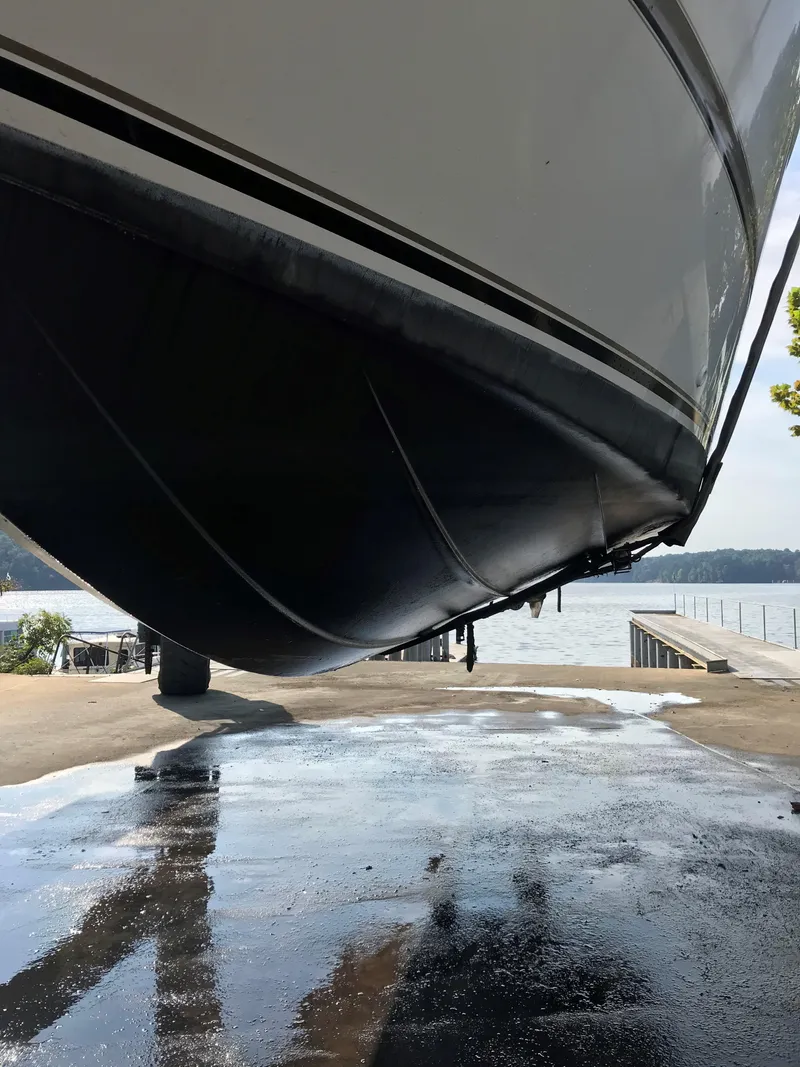 Slide: The Image of 2000 Maxum 3300 SCR boat hull on dry dock near water. - 34