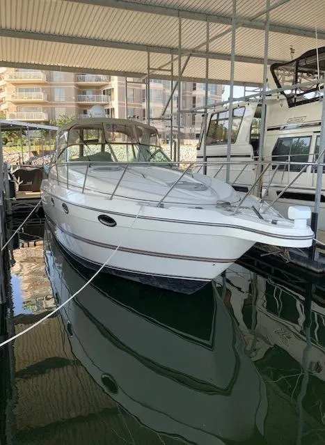 Slide: The Image of 2000 Maxum 3300 SCR boat docked in a marina. - 4