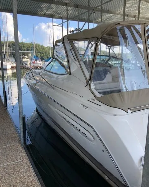 Slide: The Image of 2000 Maxum 3300 SCR boat docked in a marina. - 6