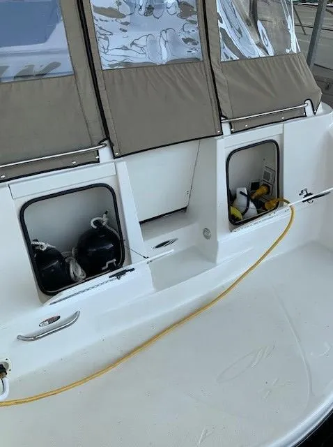 Slide: The Image of 2000 Maxum 3300 SCR boat stern with storage compartments and yellow power cord. - 9