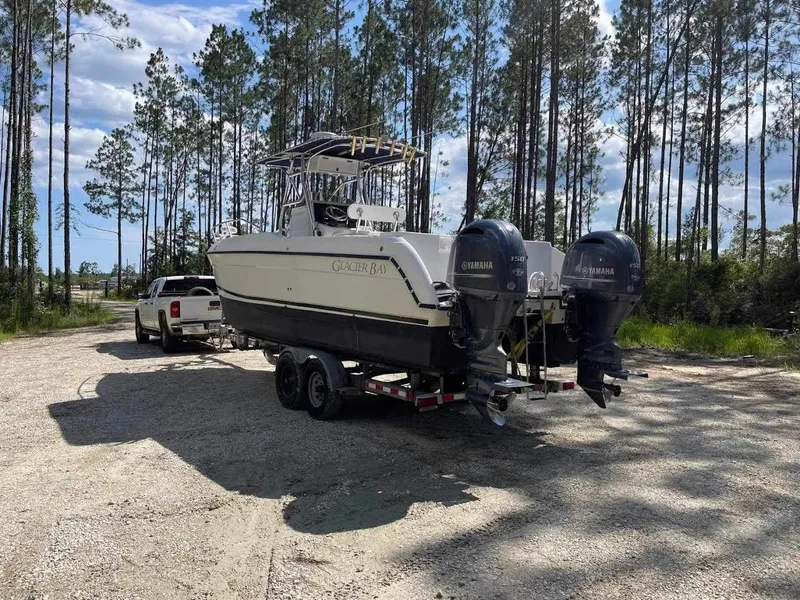 Slide: The Image of 2000 Glacier Bay 260 Canyon Runner boat on trailer in wooded area. - 11