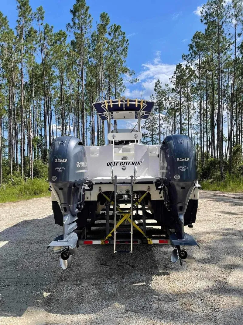 Slide: The Image of 2000 Glacier Bay 260 Canyon Runner boat with twin engines, parked outdoors. - 12