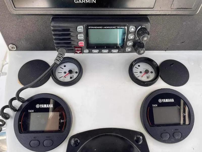 Slide: The Image of Control panel of 2000 Glacier Bay 260 Canyon Runner with Yamaha tachometers and radio. - 16