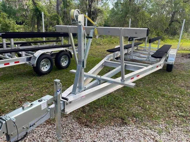 Slide: The Image of Boat trailer for 2000 Glacier Bay 260 Canyon Runner, parked on grass. - 18